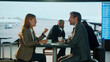 © Videophilia - Business people discussing at airport lounge bar while drinking coffee