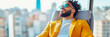 © sommersby - A confident businessman in a vibrant yellow jacket and sunglasses relaxes in an office chair, enjoying a sunny city panorama, ideal for corporate lifestyle concepts.