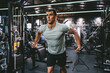 © Miljan Živković - fit man chest stretching workout on cable machine in the gym