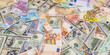 © RomanR - pile of dollar and euro banknote as background