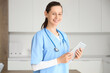 © Pixel-Shot - Female medical intern with tablet computer in clinic
