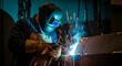 © Yulia - Skilled welder in protective gear creates sparks and light while joining metal in a workshop setting