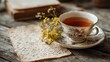 © Pixel Aria - Teacup with saucer beside handwritten recipe on wood table