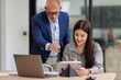 © David - Team of business office worker analyst sitting at desk working on laptop thinking on project plan, analyzing marketing or financial data online, watching elearning webinar.