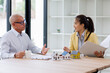 © David - Real estate agent have a meeting with customer. sale purchase property with house model & signing contract document.mortgage loan Real Estate Agent talk with client.