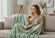 © Stockphotosbysumit - young woman sitting on sofa and drinking coffee