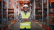 © VAKSMANV - Close up portrait of cheerful African American young professional male employee wearing hard hat standing in retail warehouse with many shelves and goods in boxes smiling at camera, positive mood