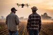 © ЮРИЙ ПОЗДНИКОВ - Farmers using drone technology for precision agriculture at sunset