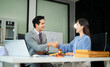 © Nuttapong punna - Professional business partners sealing a successful deal with handshake, showcasing trust, partnership
