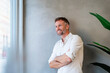 © Westend61 - Confident business professional smiling in modern office portrait