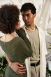 © Bliss - Young couple sharing a tender moment surrounded by vibrant plants and soft natural light
