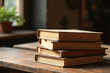 © Nichapa888 - A neat stack of vintage books placed on a rustic wooden table in warm natural lighting