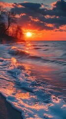 Wall Mural - sunset over the ocean with waves reflecting light. perfect for covers and backgrounds.