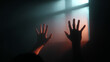 © Prostock-studio - This Hands reaching towards a window in a low-lit space, conveying feelings of struggle and isolation.