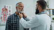 © fryktovyi - Doctor examining senior man lymph nodes in medical office