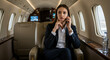 © Mei Studio - Businesswoman talking on phone in private jet for business travel