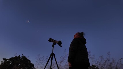 Wall Mural - amateur astronomer using camera and lens for photographing stars, moon, planets and other celestial 
