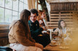 © qunica.com - A group of friends sharing a moment together in a cozy, conversational atmosphere.