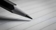© artificial_azad! - Close up of a sharpened pencil tip poised over lined paper ready to write