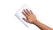 © TransPicHub - A hand is wiping a white surface with a folded white cloth against a black background.