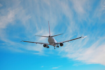 Wall Mural - airplane flying in beautiful blue sky with clouds