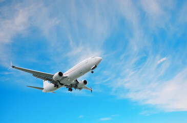 Wall Mural - airplane flying in beautiful blue sky with clouds