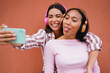© Sabrina - Happy latin girls taking a selfie with listening music with wireless headphones - Generation z, lifestyle and young people concept