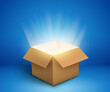 © kolonko - Open cardboard box with glowing light beams shining from inside on blue background symbolizing mystery surprise or discovery concept