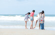 © Wosunan - Happy children playing together in the sea, enjoying a fun summer day at the beach