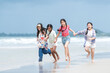 © Wosunan - Happy children playing together in the sea, enjoying a fun summer day at the beach
