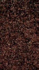 Wall Mural - swarm of small golden-orange particles floating on a black background, evoking dust, stars, or data 