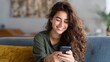 © Johannes - Happy hispanic teen girl holding cell phone using smartphone device at home. Smiling young latin woman blogger subscribing new social media, buying in internet, ordering products online in apps., no