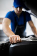 © zphoto83 - Mechanic working on vehicle maintenance with tools in a garage setting
