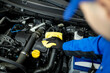 © zphoto83 - Mechanic cleaning engine components in automotive workshop during daytime maintenance session