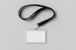 © Kamil - A horizontal transparent plastic ID card holder with a blank white card inside, attached to a black lanyard, the lanyard arranged naturally on a smooth, light gray, textureless background
