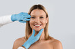© Prostock-studio - Portrait of smiling middle aged beautiful blonde woman getting prepared for plastic surgery procedures by doctor touching her face skin, isolated on grey background, copy space