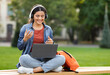 © Prostock-studio - Online education, webinar, course. Happy beautiful young indian woman student have online class while chilling at park, using laptop and wireless headphones, pass online exam, video call with tutor