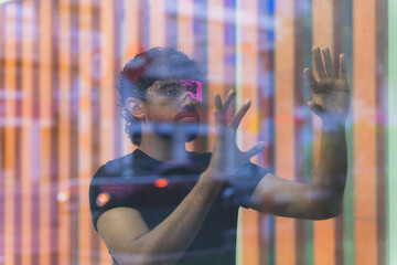 Latin software developer using augmented reality headset and interacting with a holographic interface