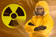 © New Africa - Man wearing hazmat suit and gas mask in smoke. Radioactive sign on orange gradient background