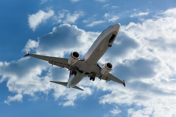 Wall Mural - airplane flying in beautiful blue sky with clouds