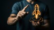 © Robert - A male individual of uncertain ethnicity points at a glowing rocket icon, symbolizing innovation and ambition in technology and entrepreneurship against a dark background.