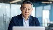 © Arifyoga - Serious businessman at laptop