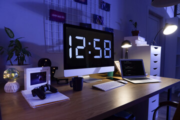 Wall Mural - programmer's desk with computer and laptop in office at night