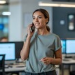 © shahidhasan100 - Smiling woman in casual office attire talking on her mobile phone