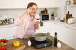 © Pixel-Shot - Young pregnant woman making soup at table in kitchen