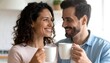 © Ariesshitoku - Smiling affectionate couple enjoying their morning coffee together at home, looking at each other with love and tenderness