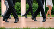© Bakha - Group of diverse adults performing synchronized ballroom dance routine outdoors on wooden floor in summer evening, close up on stylish footwear and elegant leg movements