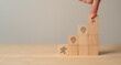 © Parradee - Career Path and Development Strategy Concept. Arranging wooden blocks with icons success roadmap and journey, symbolizing a structured career path and strategic development. Planning, growth, progress