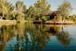 © Cavan Images - Teenagers fishing and playing in a peaceful lake