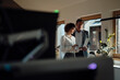 © Westend61 - Colleagues working together in a sunny modern office with laptop